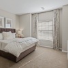 Large well lit bedroom with wood floors 